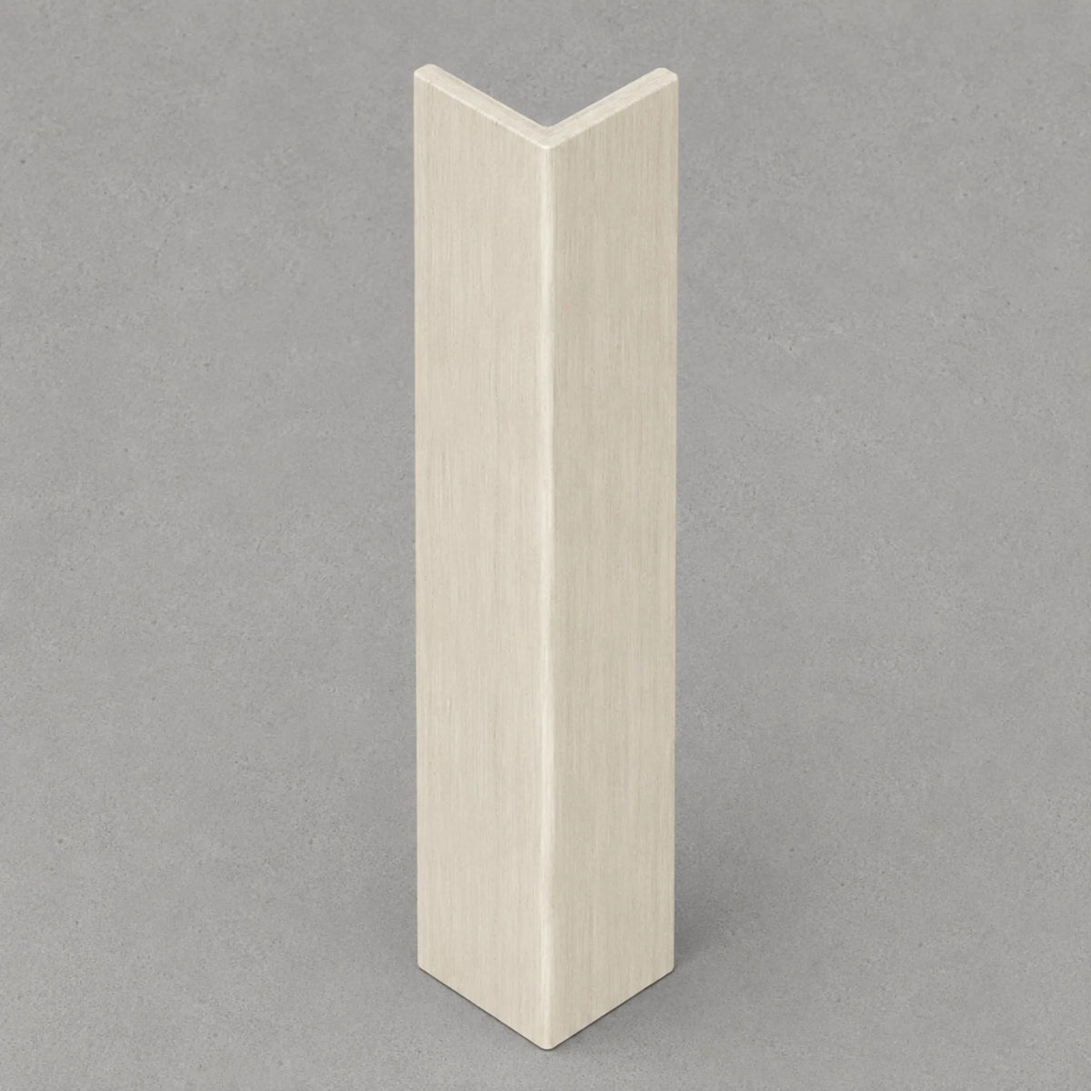 Cool beige travertine corner trim by NU Wall, showcasing a smooth, natural stone finish designed for elegant wall corner accents.