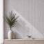 NU Wall Luxe White Washed Travertine Reeded Panel wall panel with textured, white washed travertine surface and reeded design.
