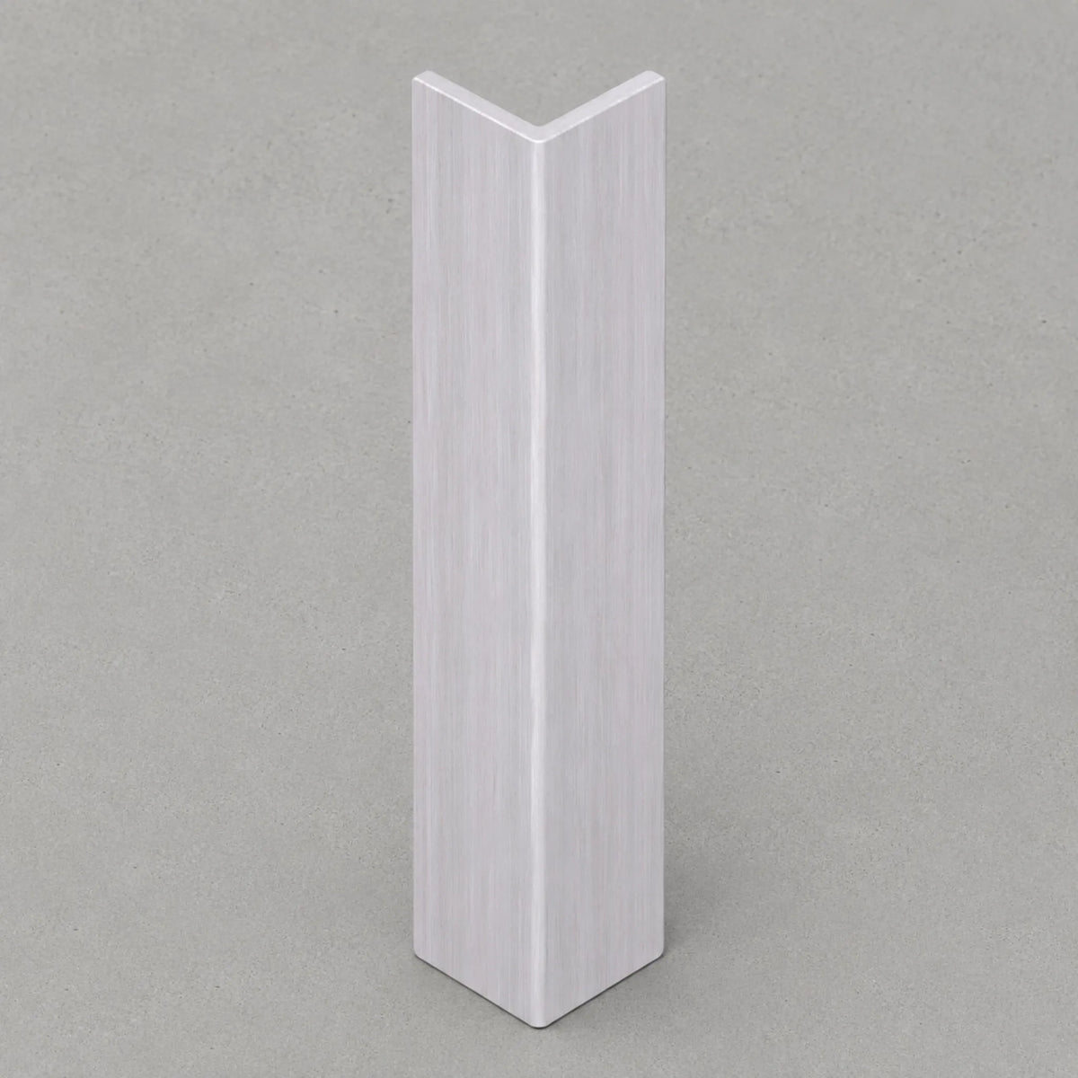 White washed travertine corner trim by NU Wall, showcasing smooth, polished surface and clean edge for wall finishing.