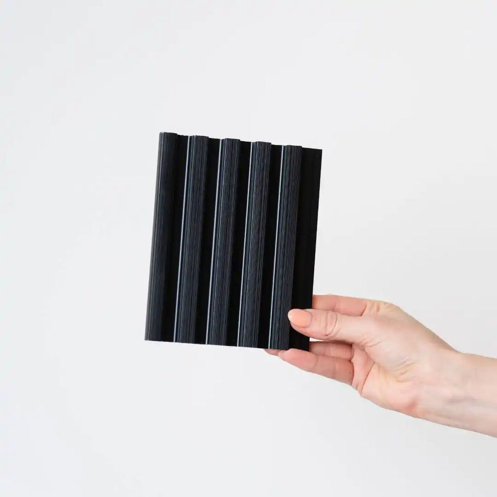 Set of four NU Wall brushed black small slatted wall panels showing textured, modern design for interior wall decoration.