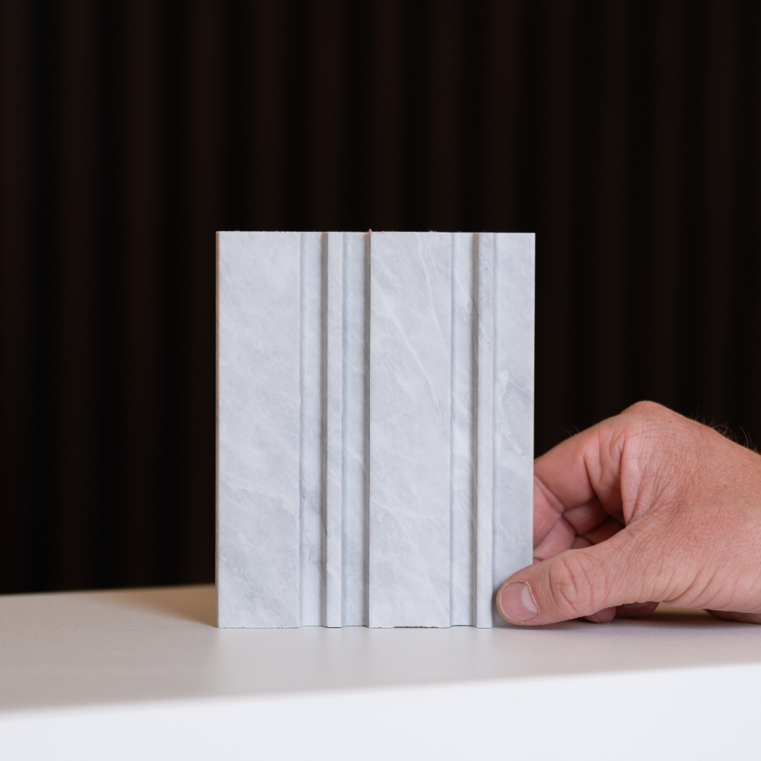 NU Wall Dubai Cloudy Grey slatted wall panel sample showing textured grey slats on a sample board.