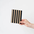 NU Wall small slatted wall panels in light oak and black, showing four panels with modern, textured wood design for interior decor.