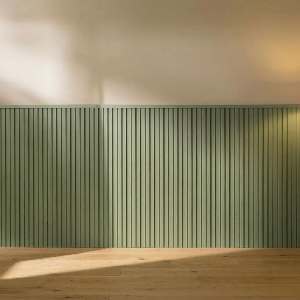 Four NU Wall Elegance Apex paintable wall panels with textured surface, stacked and leaning against a plain wall.
