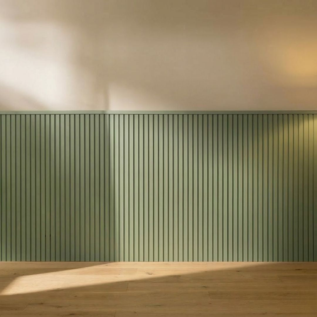 Four NU Wall Elegance Apex paintable wall panels with textured surface, stacked and leaning against a plain wall.