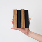 NU Wall Residence pack of 4 medium oak and black slatted wall panels on a wall, showcasing modern interior decor design.