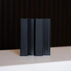 Set of four NU Wall Residence brushed black slatted wall panels, showcasing modern textured wood grain design for interior decor.