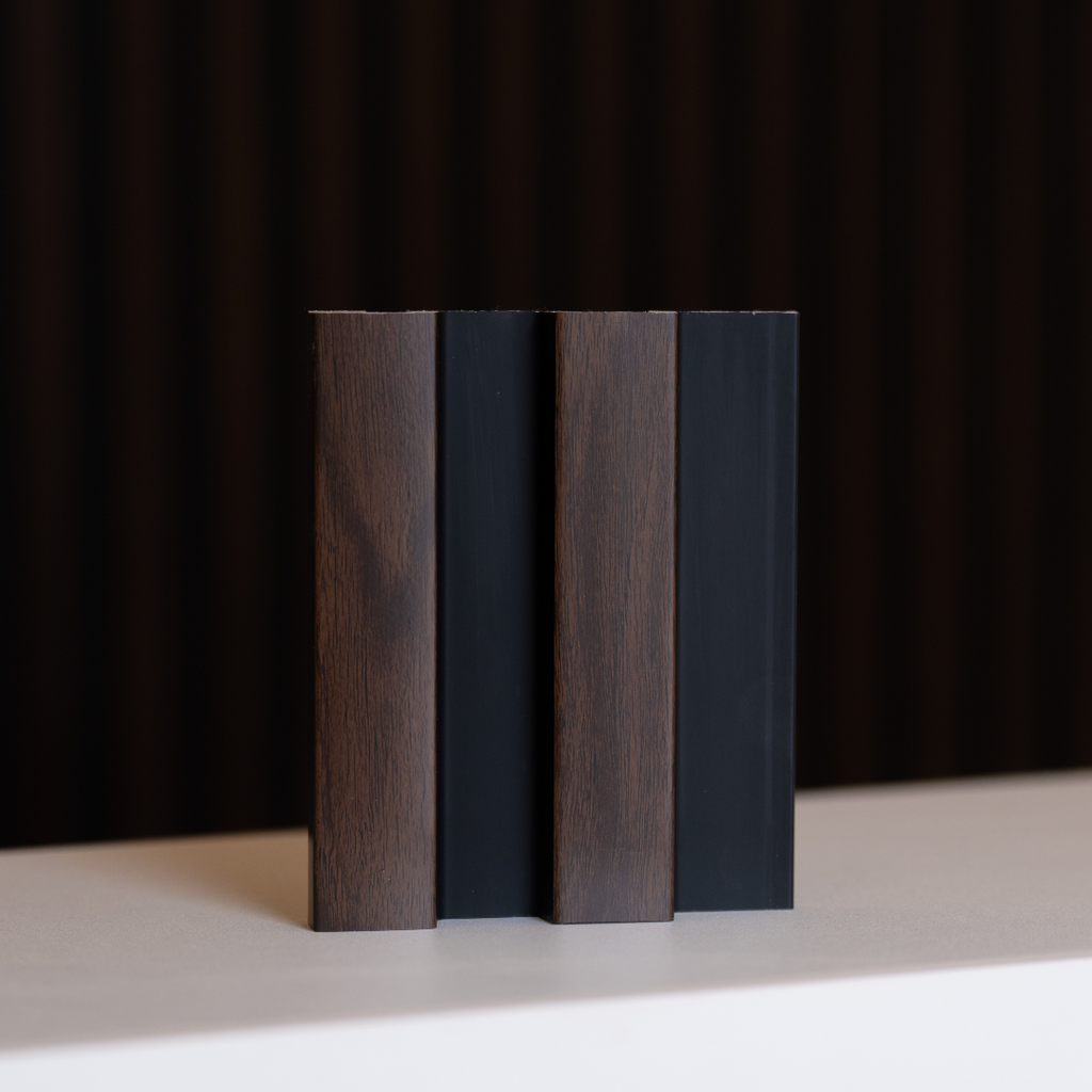 NU Wall Residence dark oak and black slatted wall panel sample showing textured wood grain and modern design elements.