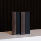 NU Wall Residence dark oak and black slatted wall panel sample showing textured wood grain and modern design elements.