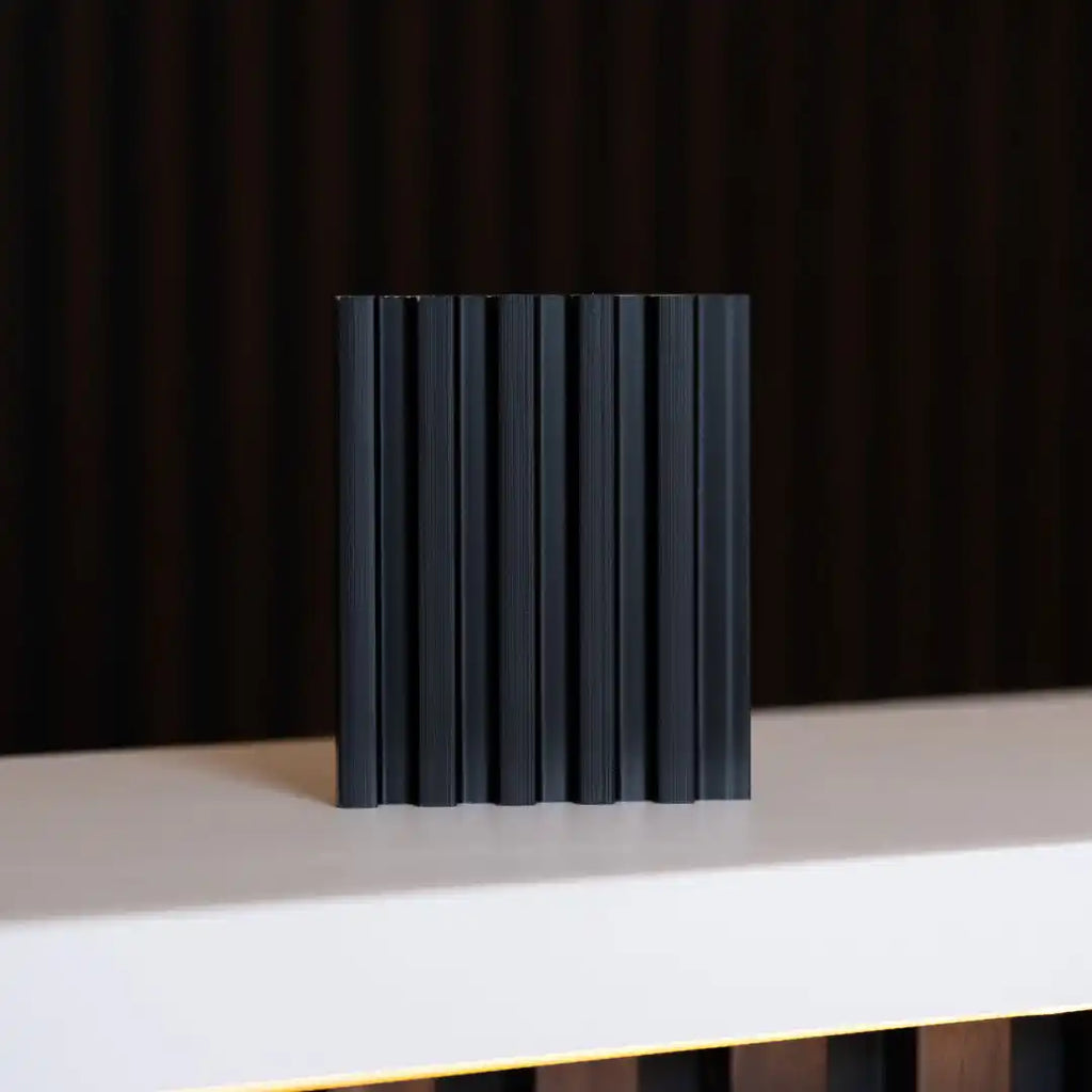 NU Wall Palm Brushed Black small slatted wall panel sample showing textured black slats and sample dimensions.