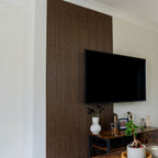 Set of four NU Wall Arc Reeded Warm Oak wall panels showcasing textured wood grain and elegant reeded design.